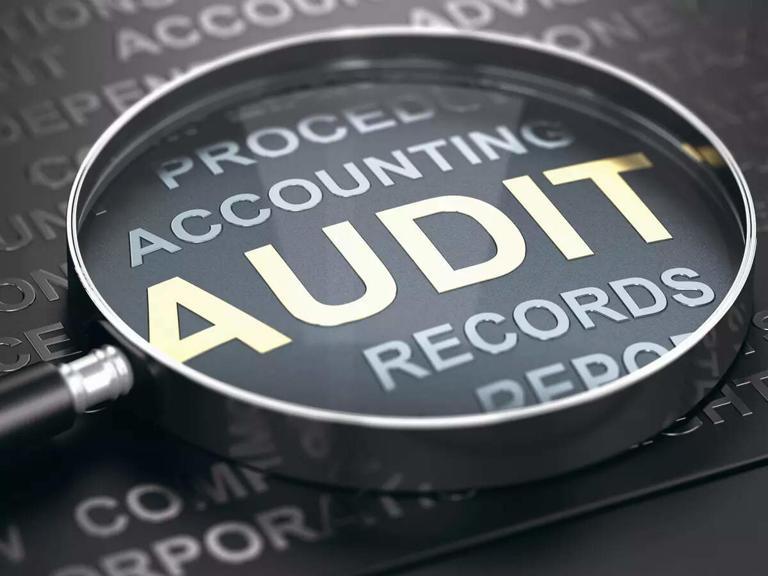 Magnifying glass over accounting audit records