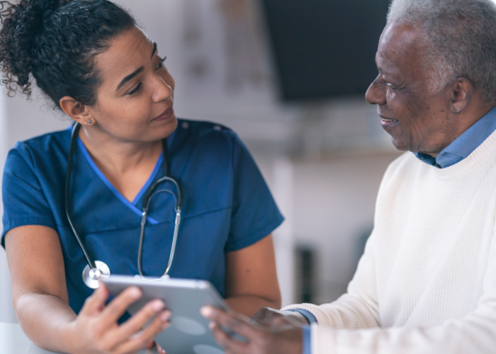 Nurse reviewing well-care records with an elderly patient